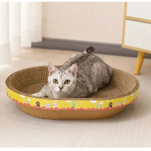 Cat using a yellow oval cardboard scratcher