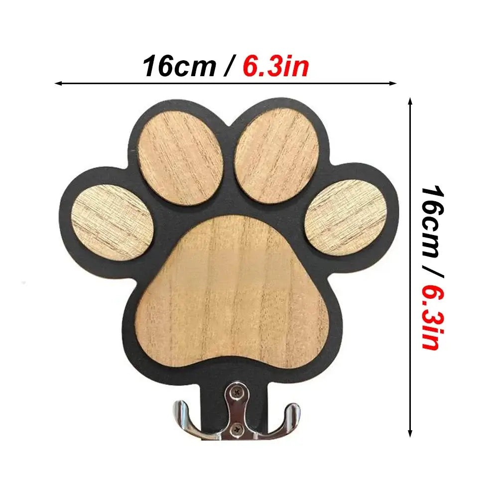 Wooden leash hanger in a paw shape with wall-mounted hook for easy access to leashes and collars.